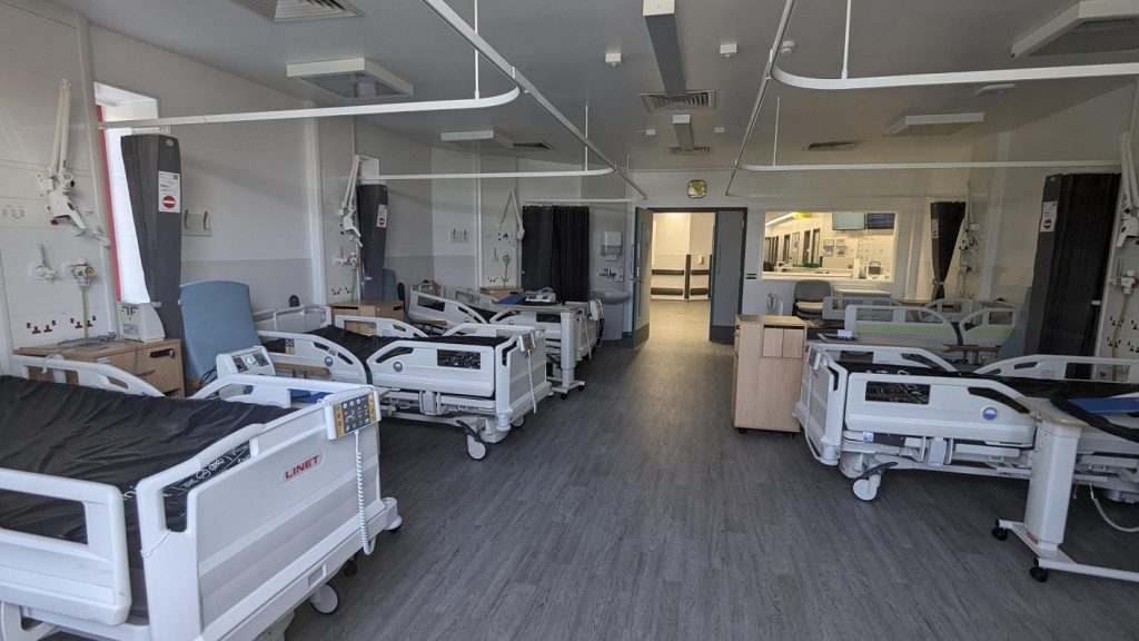 Beds on a redecorated hospital ward. 