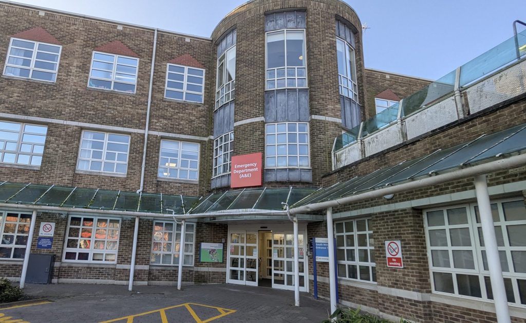 A front of a building. A sign above the door reads Emergency Department (A&E).