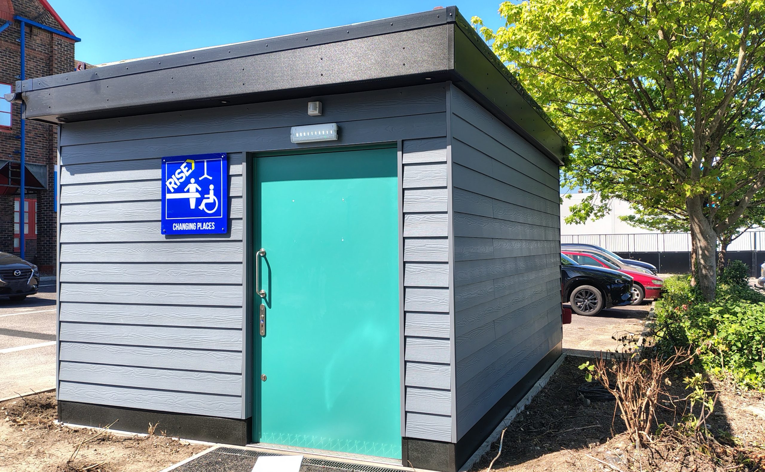 A small building with Changing Places written on a blue sign on the front.