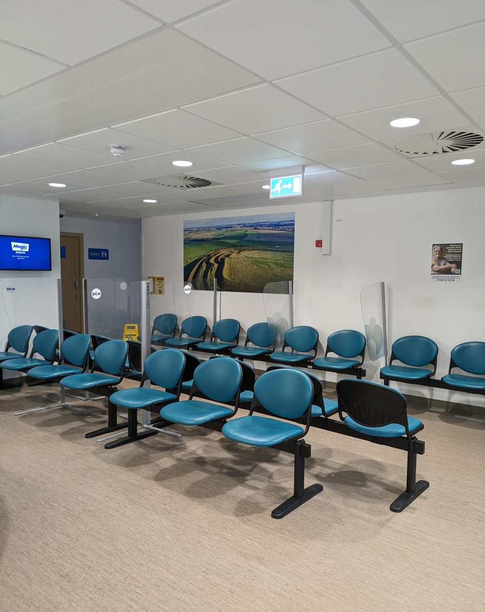 Rows of chairs in a brightly lit room.