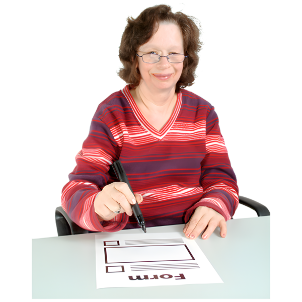 A person sitting at a desk, filling out a form.