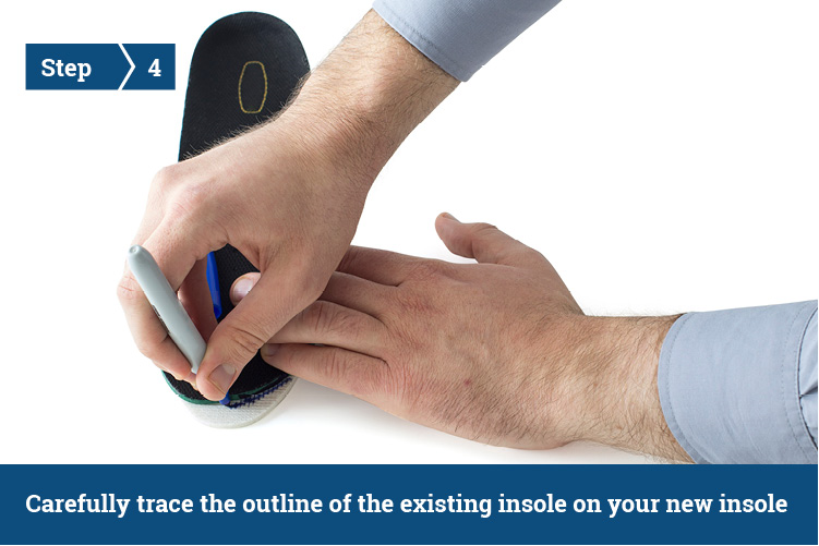 A person tracing the outline of an existing shoe insole onto a new insole with a pen.