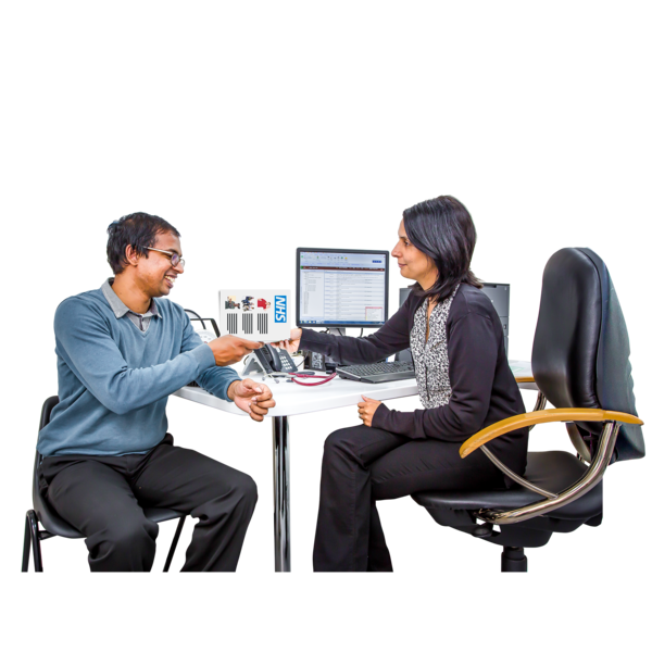 Two professionals shaking hands across a desk with a computer displaying graphs. One is seated on a wheeled chair and the other on a stationary chair, both smiling in a well-lit office setting.