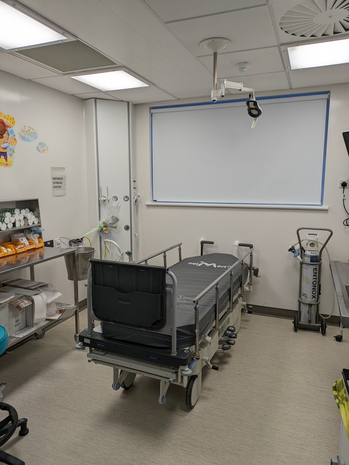 A hospital room with equipment and a bed.
