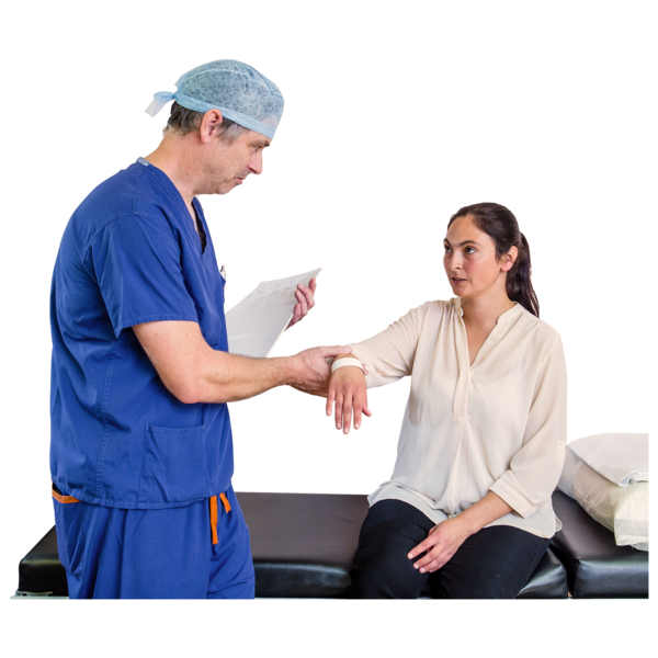 A doctor dressed in scrubs is checking the pulse of a patient on a bed.