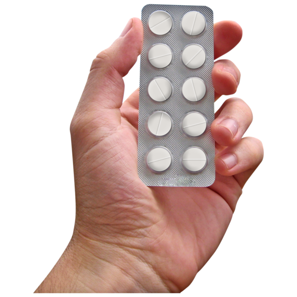 A person holding a strip of tablets.