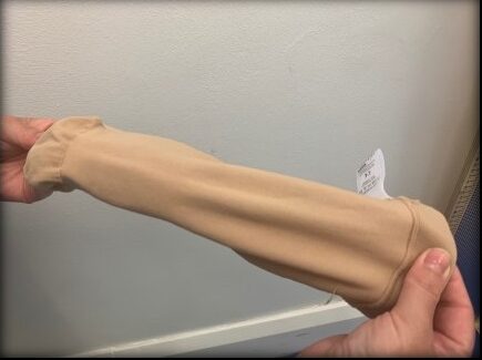A person holding a compression garment.