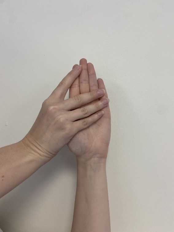 A person placing one hand over another.