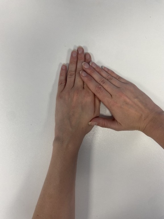 A person placing one hand over another.