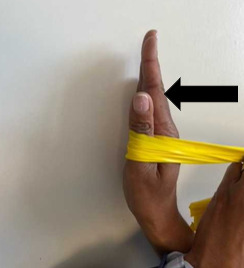 A person demonstrating hand exercises with a yellow band.